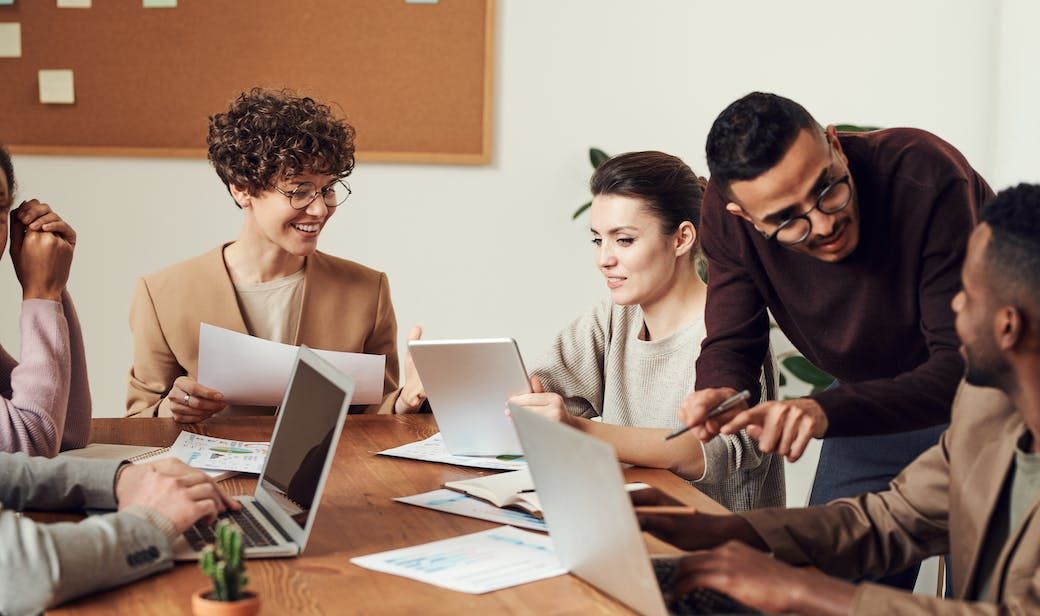 Group of people gathered around wooden table
